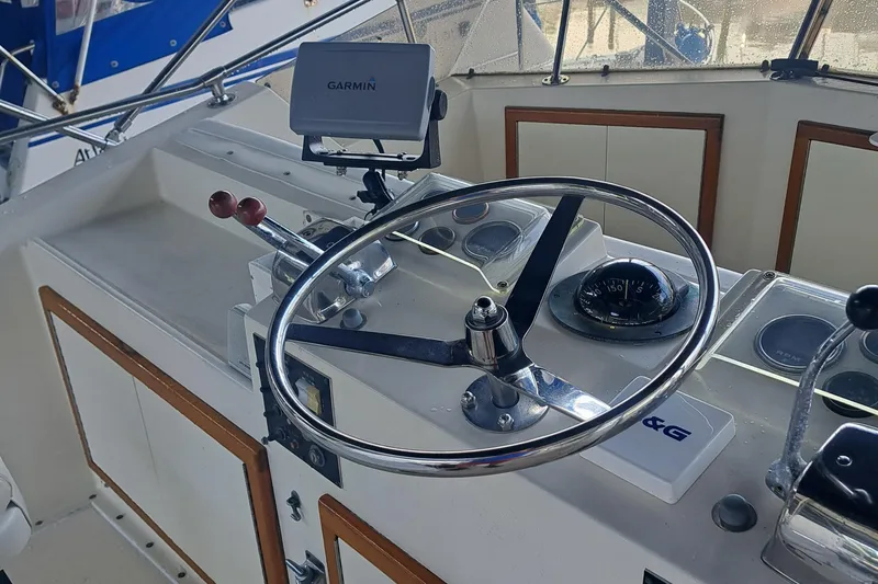 Slide: The Image of 1978 Hatteras 37 Convertible helm with Garmin navigation and classic steering wheel. - 8