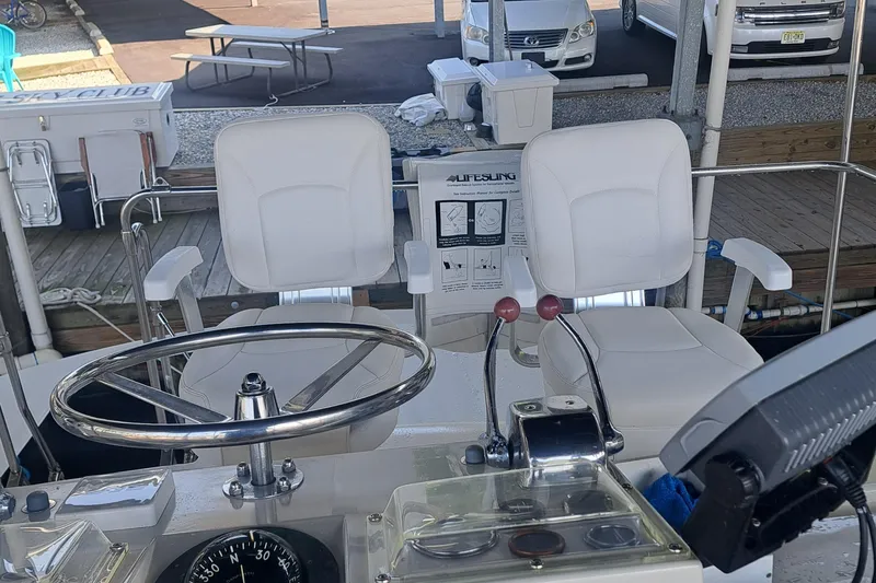 Slide: The Image of Helm of 1978 Hatteras 37 Convertible with dual white captain chairs and steering wheel. - 9