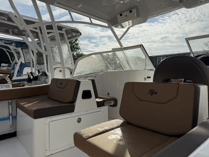 Slide: The Image of 2025 Sea Pro 240 DLX boat interior with brown seating and modern design. - 4