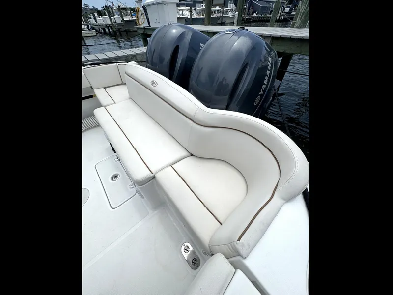 Slide: The Image of 2022 Sea Hunt Ultra 275 SE boat with white seating and dual Yamaha engines. - 34