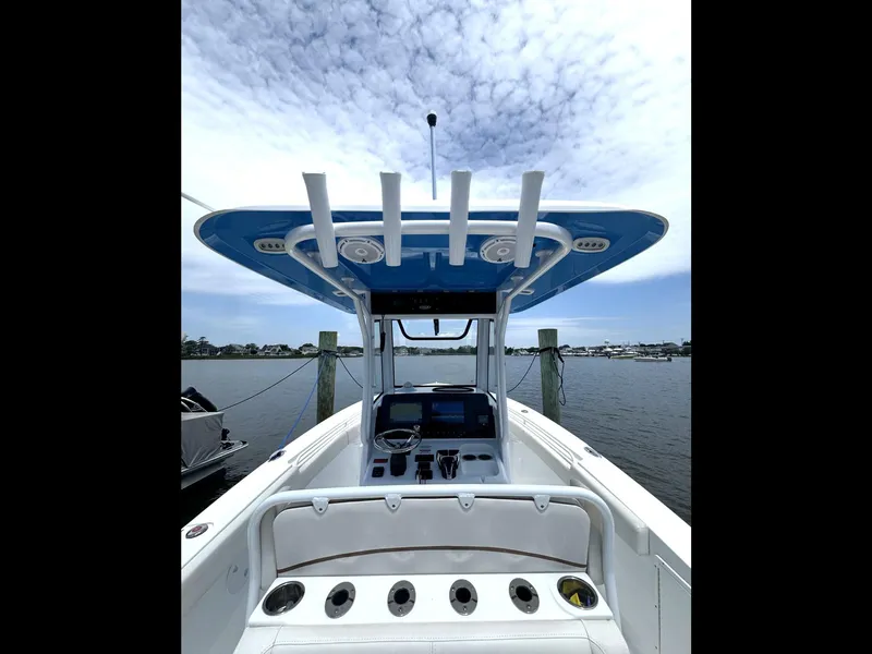 Slide: The Image of 2022 Sea Hunt Ultra 275 SE boat interior with helm and rod holders. - 41