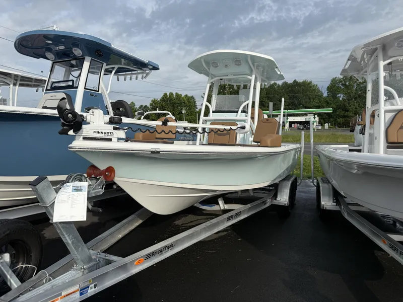 The Image of 2025 Sea Pro 230 Bay boat on trailer, featuring Minn Kota trolling motor. - 1