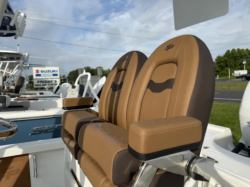 Slide: The Image of 2025 Sea Pro 230 Bay boat with tan leather seats, displayed outdoors. - 5