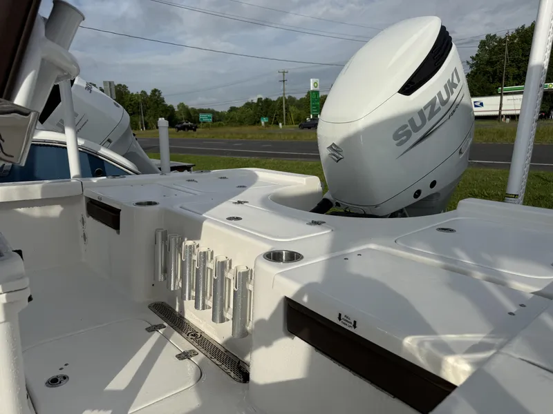 Slide: The Image of 2025 Sea Pro 230 Bay boat with Suzuki outboard motor, featuring rod holders and spacious deck. - 6