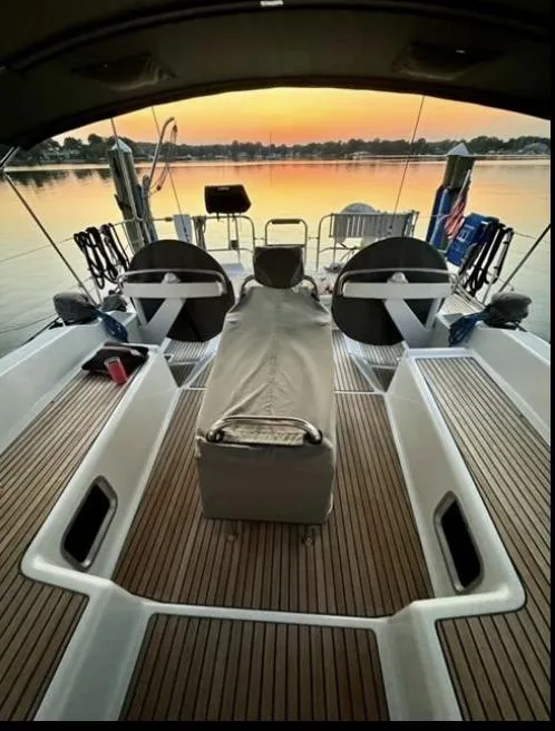 Slide: The Image of 2016 Jeanneau Yachts 58 cockpit with canopy, sailing on open water. - 7