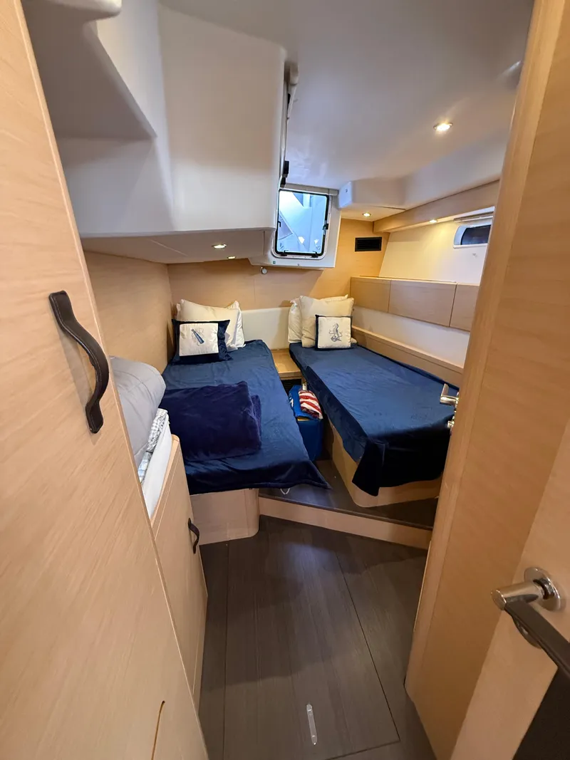 Slide: The Image of Interior cabin of 2016 Jeanneau Yachts 58 with twin beds and nautical decor. - 12