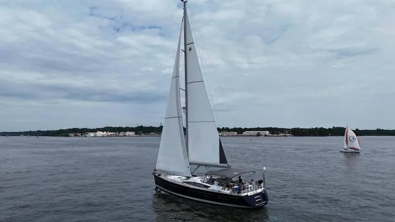 Slide: The Image of 2016 Jeanneau Yachts 58 sailing on a calm sea under a cloudy sky. - 21