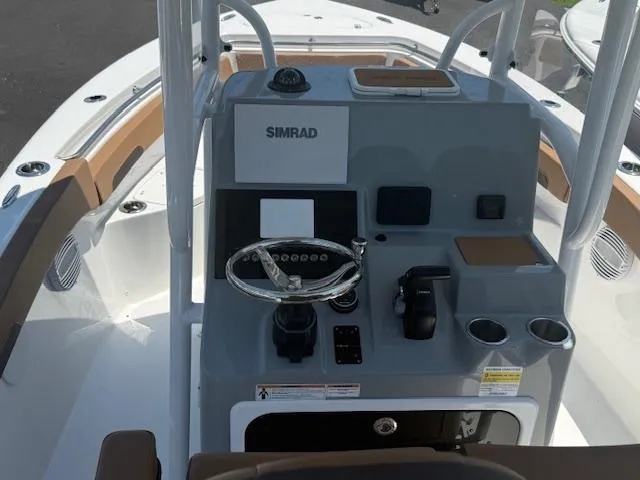 Slide: The Image of 2025 Sea Pro 222 Center Console boat dashboard with steering wheel and navigation equipment. - 3