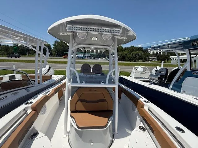 Slide: The Image of 2025 Sea Pro 222 Center Console boat with seating, displayed outdoors on a sunny day. - 7