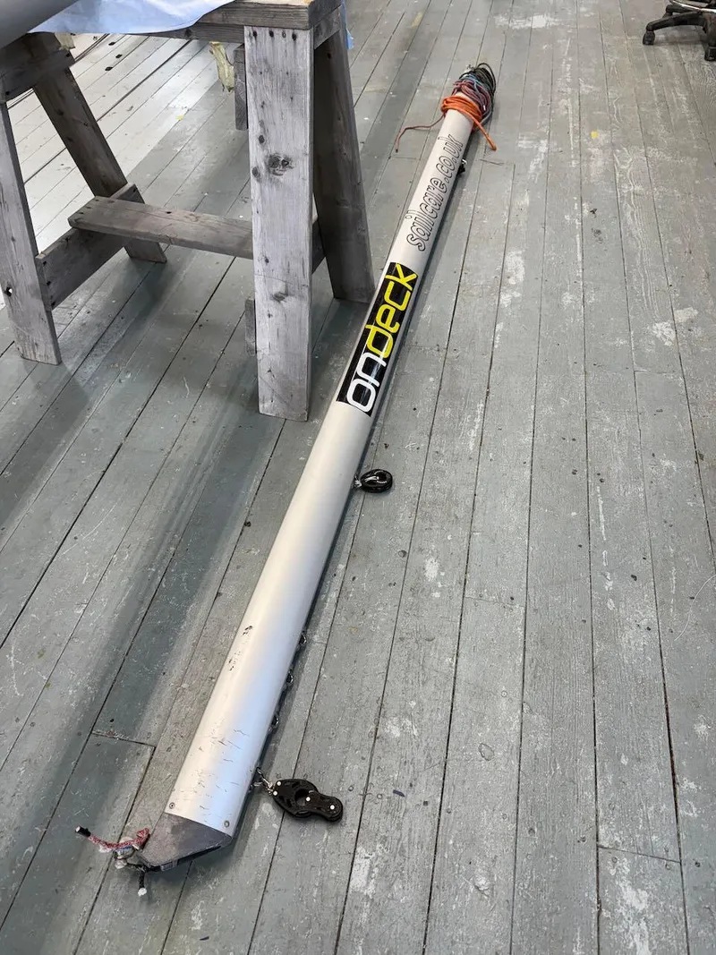 Slide: The Image of Mast of 2006 Mas Mini Transat 6.50 sailboat on wooden floor. - 21