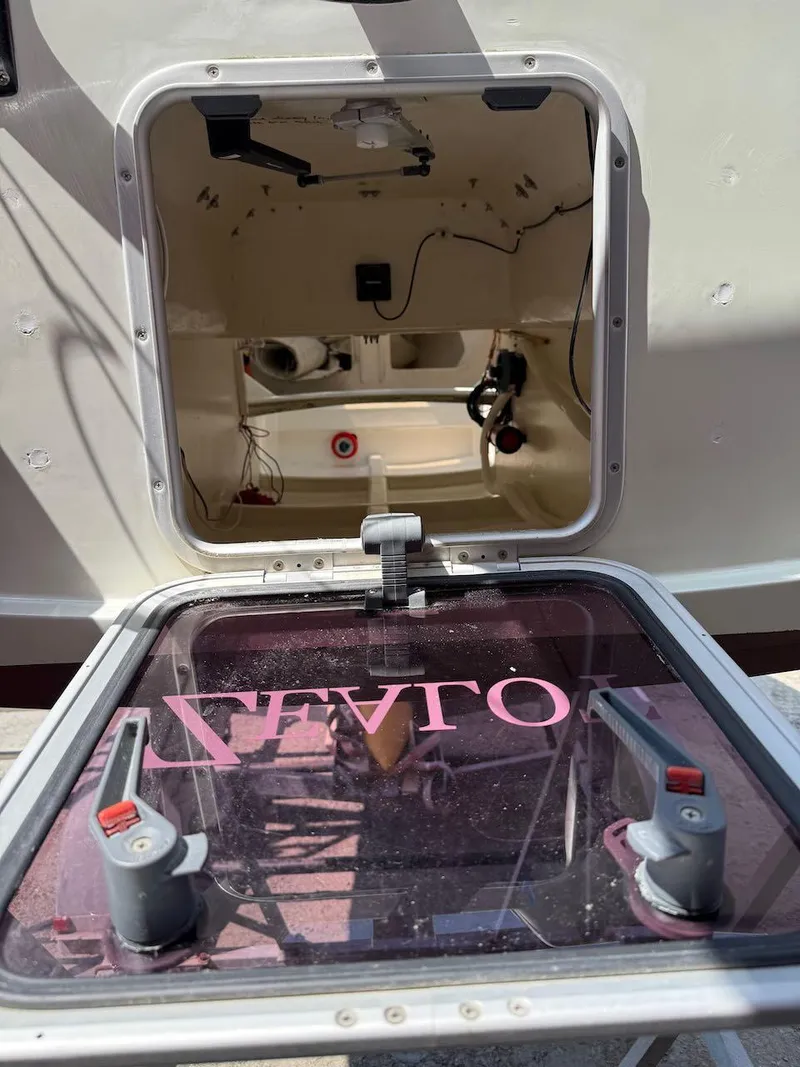 Slide: The Image of Open hatch of 2006 Mas Mini Transat 6.50 sailboat, showing interior details. - 26