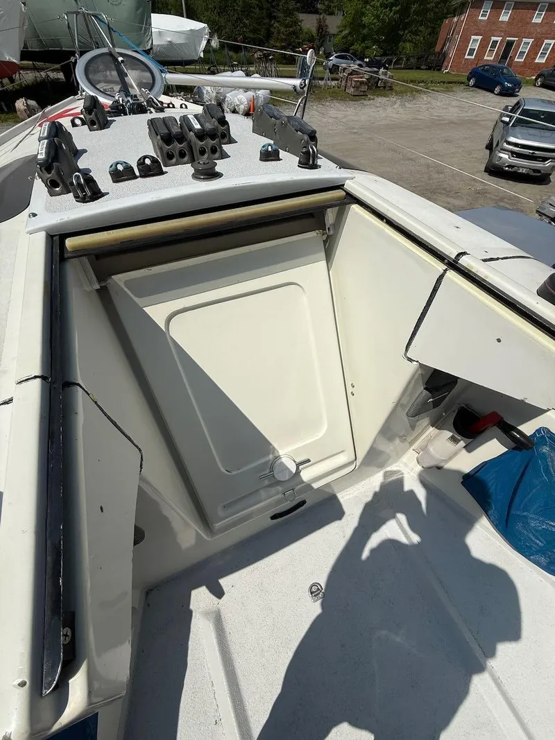 Slide: The Image of 2006 Mas Mini Transat 6.50 sailboat cockpit with storage compartment and equipment. - 35
