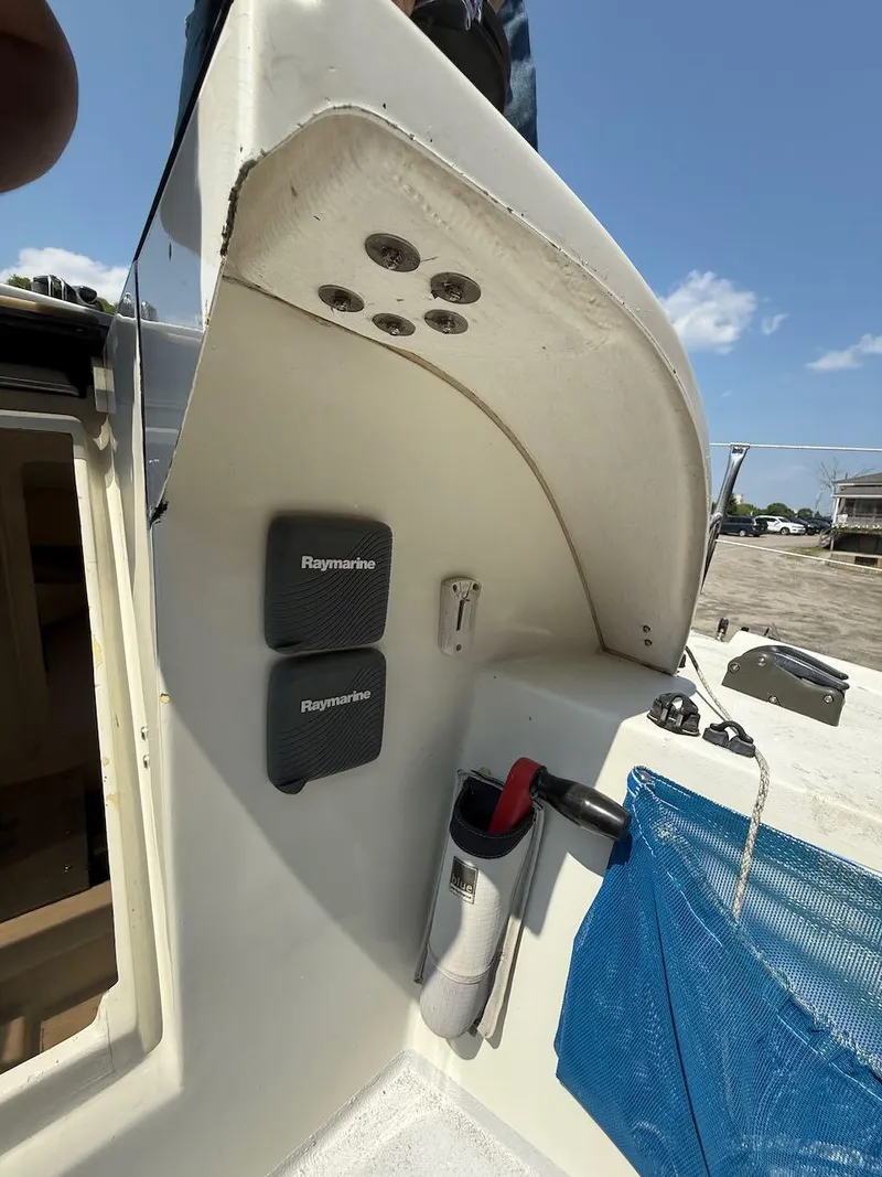 Slide: The Image of 2006 Mas Mini Transat 6.50 cockpit with Raymarine equipment and storage compartments. - 36