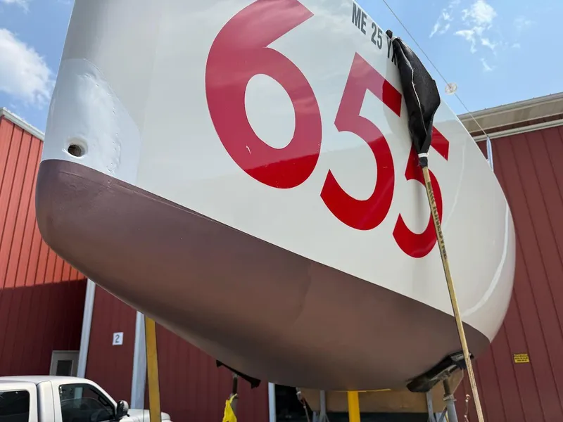 Slide: The Image of Mas Mini Transat 6.50 sailboat, number 655, displayed outdoors, 2006 model. - 4