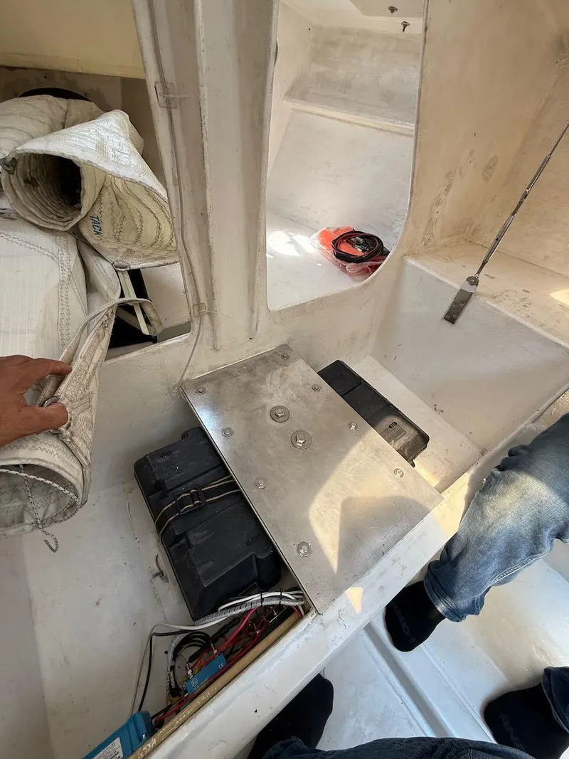 Slide: The Image of Interior of 2006 Mas Mini Transat 6.50 sailboat showing equipment and storage area. - 42