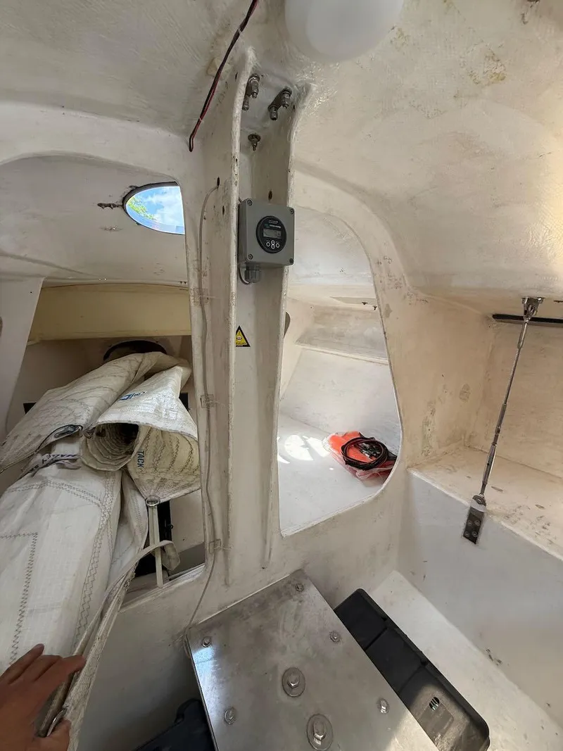 Slide: The Image of Interior of 2006 Mas Mini Transat 6.50 sailboat, showing cabin details and equipment. - 43