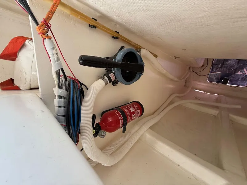 Slide: The Image of Interior of 2006 Mas Mini Transat 6.50 sailboat with fire extinguisher and wiring. - 45