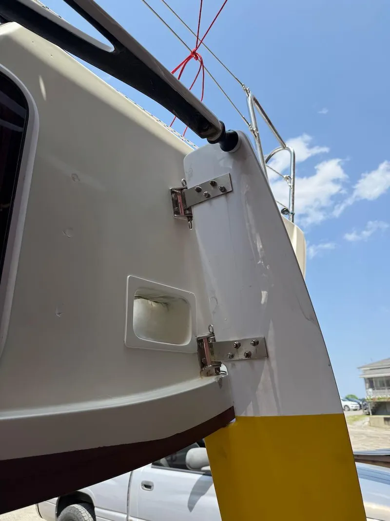 Slide: The Image of Close-up of a 2006 Mas Mini Transat 6.50 sailboat rudder and hinge mechanism. - 7