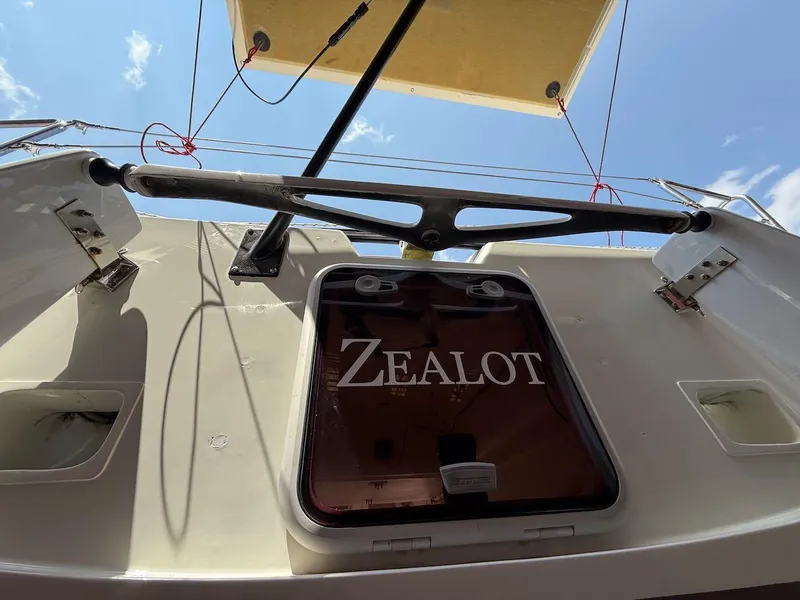Slide: The Image of Sailboat "Zealot" hatch, Mas Mini Transat 6.50, 2006, under clear blue sky. - 8