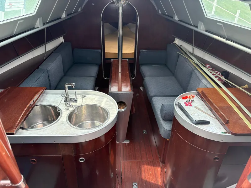 Slide: The Image of Interior of a 1989 Beneteau 32s5 sailboat with dual sinks and seating area. - 24