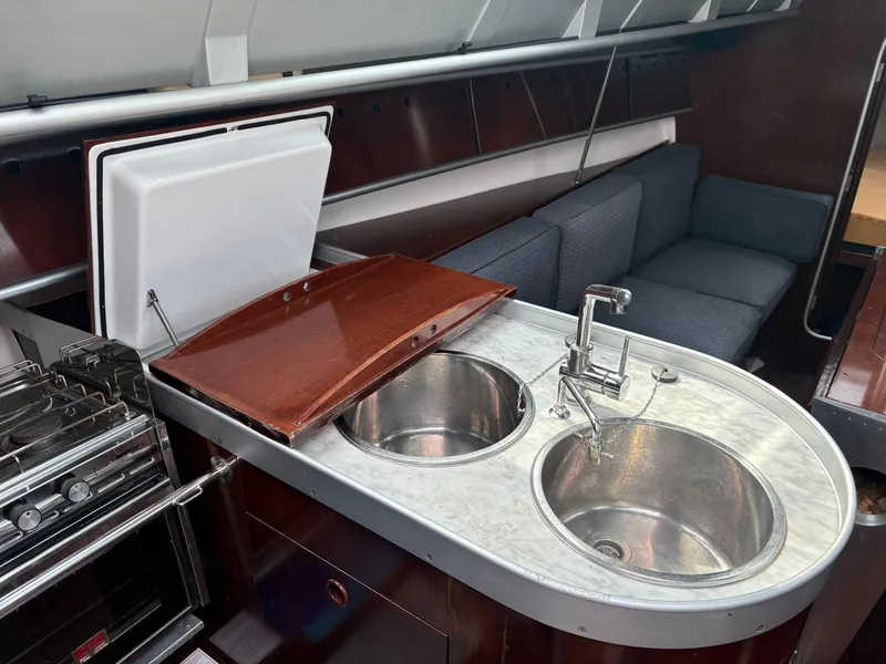 Slide: The Image of Interior of 1989 Beneteau 32s5 yacht with dual sinks and modern kitchen amenities. - 25