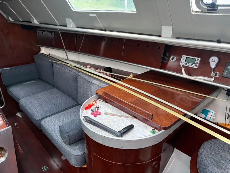 Slide: The Image of Interior of 1989 Beneteau 32s5 sailboat with blue seating and wooden cabinetry. - 27