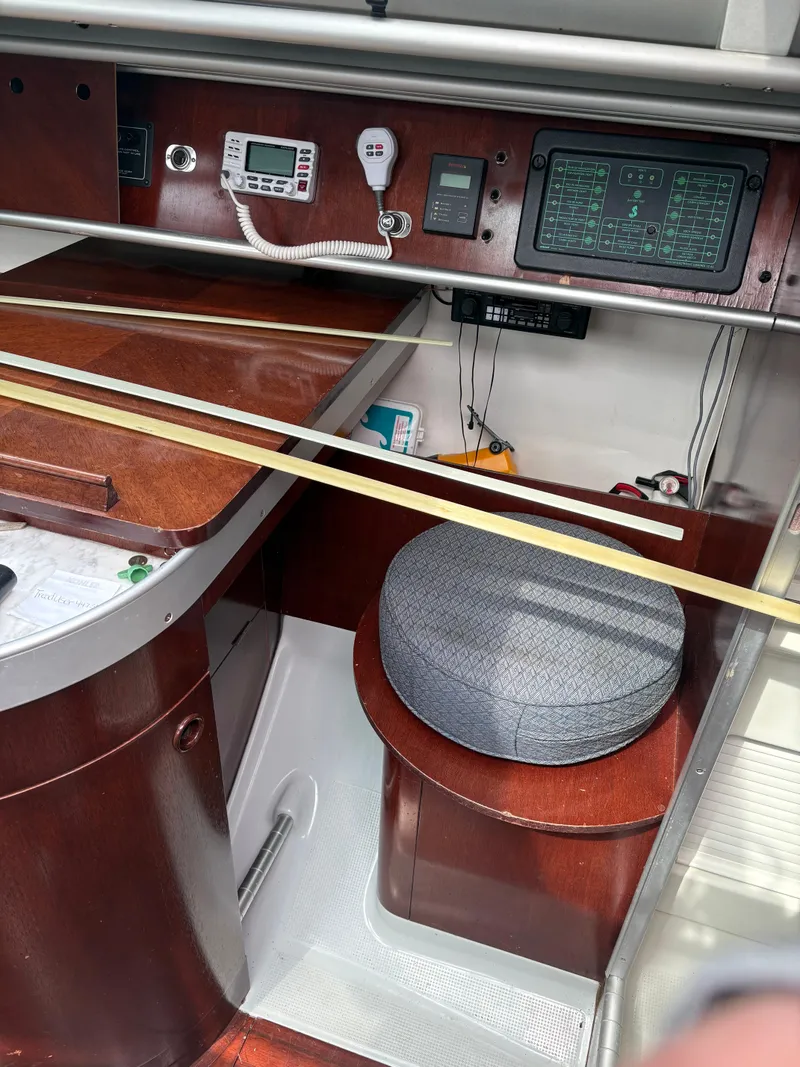 Slide: The Image of Interior of a 1989 Beneteau 32s5 sailboat with navigation equipment and seating. - 28