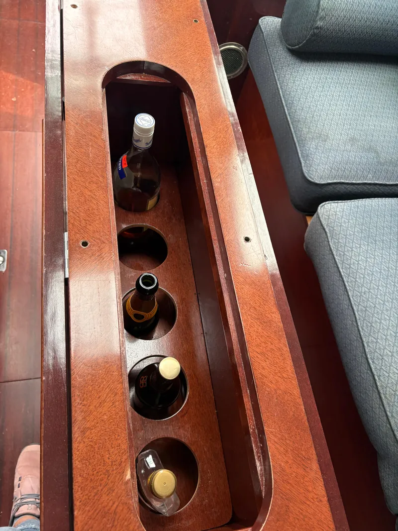 Slide: The Image of Wooden bottle holder on 1989 Beneteau 32s5 yacht interior, with four bottles. - 34