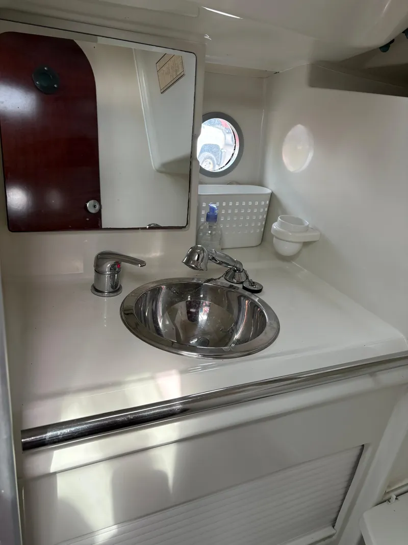 Slide: The Image of Beneteau 32s5 1989 yacht bathroom with stainless steel sink and mirror. - 38