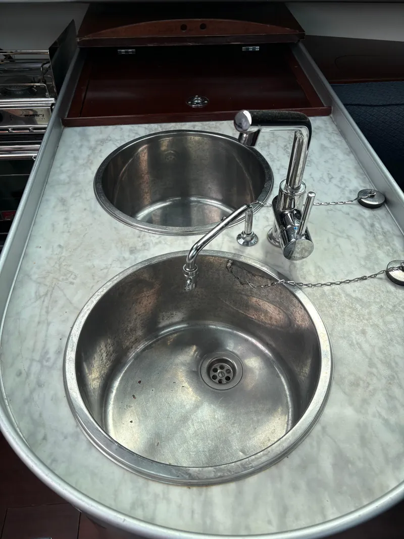 Slide: The Image of Stainless steel sink and faucet on 1989 Beneteau 32s5 yacht kitchen counter. - 41