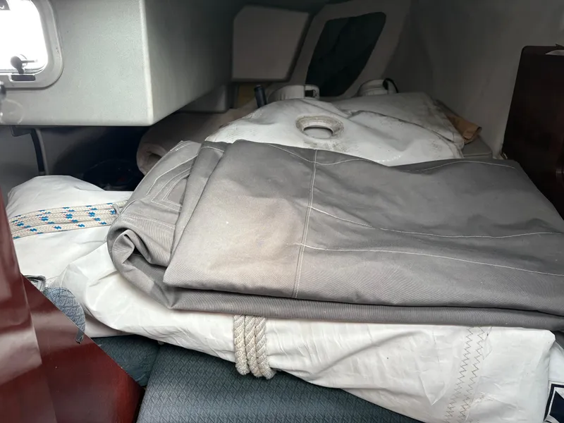 Slide: The Image of Interior of 1989 Beneteau 32s5 sailboat with folded sails and ropes. - 45