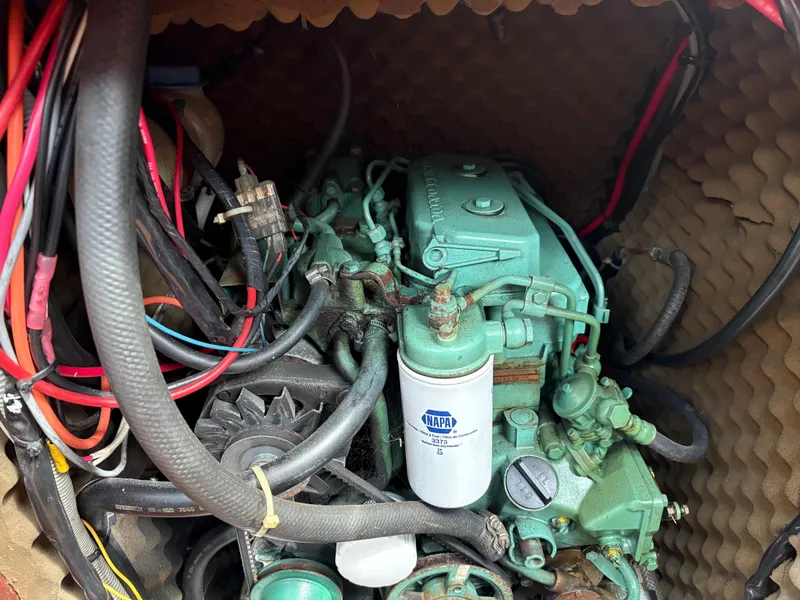 Slide: The Image of Engine compartment of a 1989 Beneteau 32s5 sailboat with visible wiring and components. - 47
