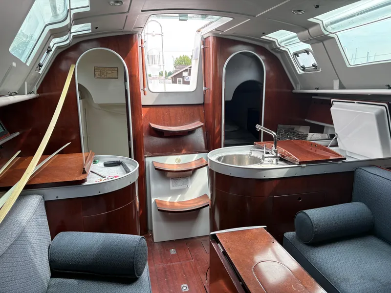 Slide: The Image of Interior of a 1989 Beneteau 32s5 sailboat with wood finishes and modern amenities. - 48