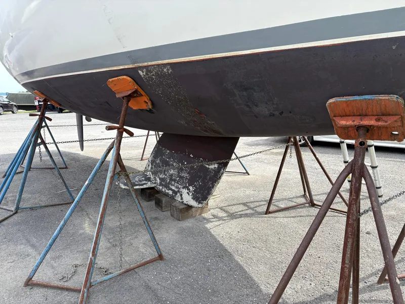 Slide: The Image of 1989 Beneteau 32s5 sailboat hull on stands, showing keel and support structures. - 5