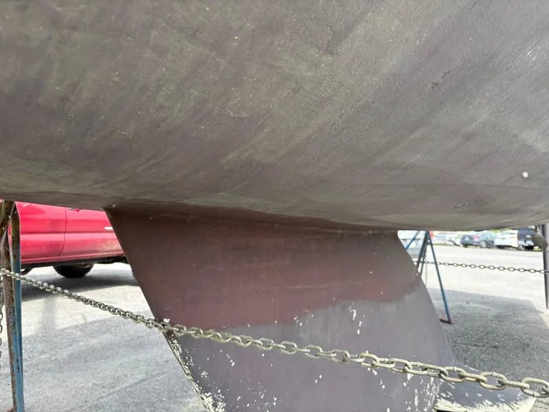 Slide: The Image of Close-up of 1989 Beneteau 32s5 sailboat hull and keel in a boatyard. - 7