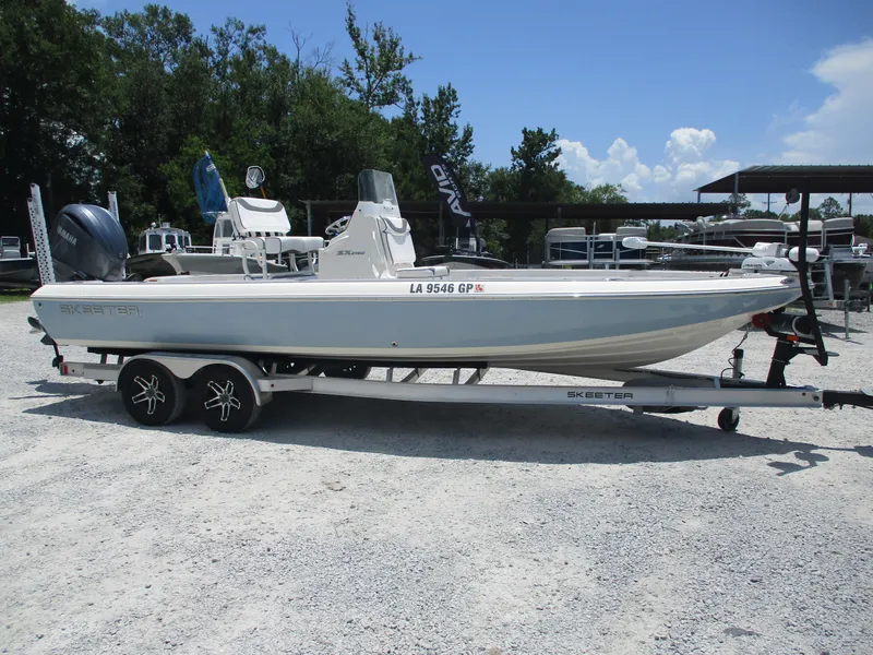 The Image of 2023 Skeeter SX 240 boat on trailer, parked outdoors under clear sky. - 0