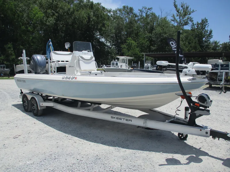 Slide: The Image of 2023 Skeeter SX 240 boat on trailer in outdoor setting. - 1