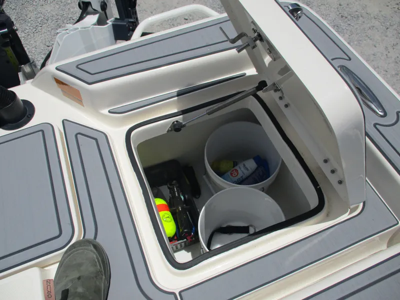 Slide: The Image of 2023 Skeeter SX 240 boat storage compartment with buckets and gear. - 12