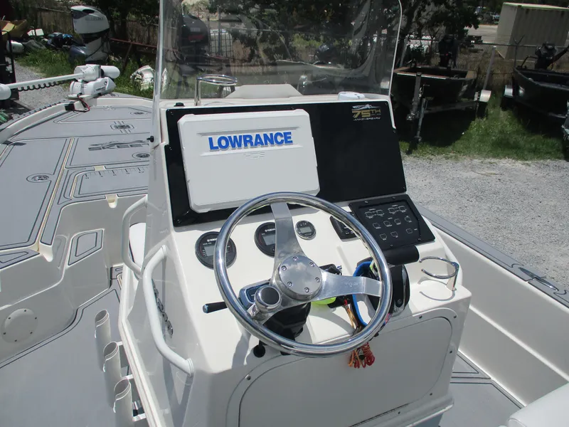 Slide: The Image of 2023 Skeeter SX 240 boat console with Lowrance electronics and steering wheel. - 13