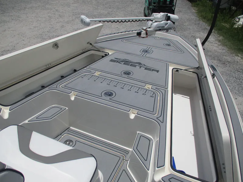 Slide: The Image of 2023 Skeeter SX 240 boat deck with storage compartments and measuring ruler. - 17