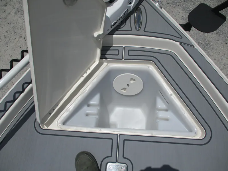 Slide: The Image of Open storage compartment on 2023 Skeeter SX 240 boat deck. - 19