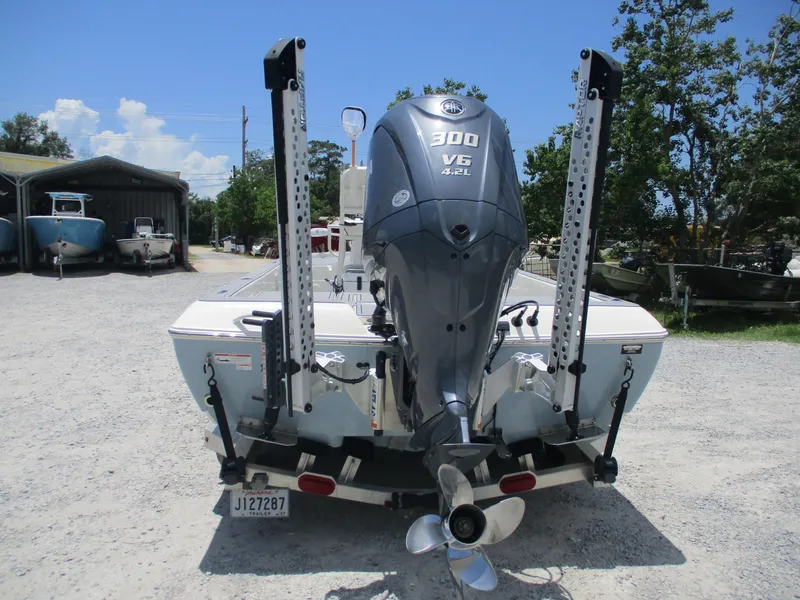 Slide: The Image of 2023 Skeeter SX 240 boat with Yamaha 300 V6 engine, parked outdoors. - 7