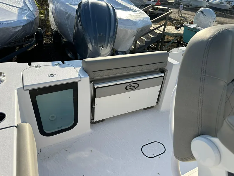 Slide: The Image of 2025 Sportsman Open 232 Center Console boat interior with seating and storage. - 14