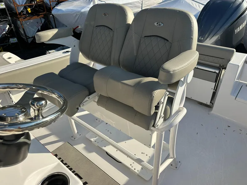Slide: The Image of 2025 Sportsman Open 232 Center Console boat with dual cushioned seats and steering wheel. - 15