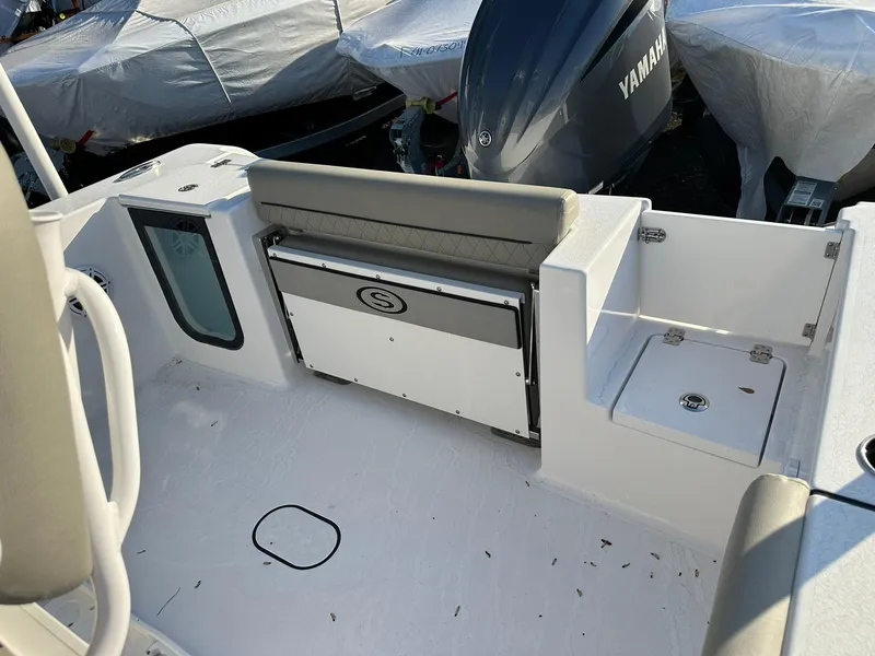 Slide: The Image of 2025 Sportsman Open 232 Center Console boat interior with Yamaha engine, featuring seating and storage. - 16