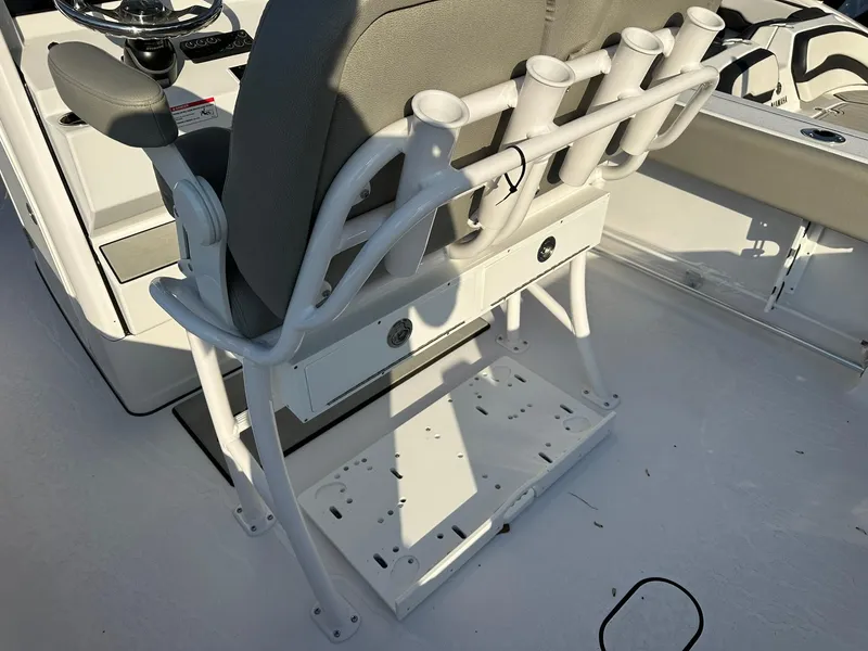 Slide: The Image of 2025 Sportsman Open 232 Center Console boat seat with rod holders and steering wheel. - 17