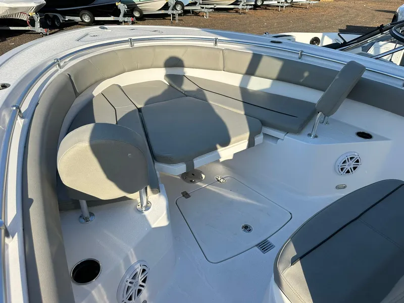 Slide: The Image of 2025 Sportsman Open 232 Center Console boat interior with cushioned seating and cup holders. - 23