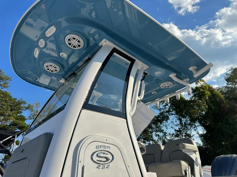 Slide: The Image of 2025 Sportsman Open 232 Center Console boat with blue T-top and speakers. - 3