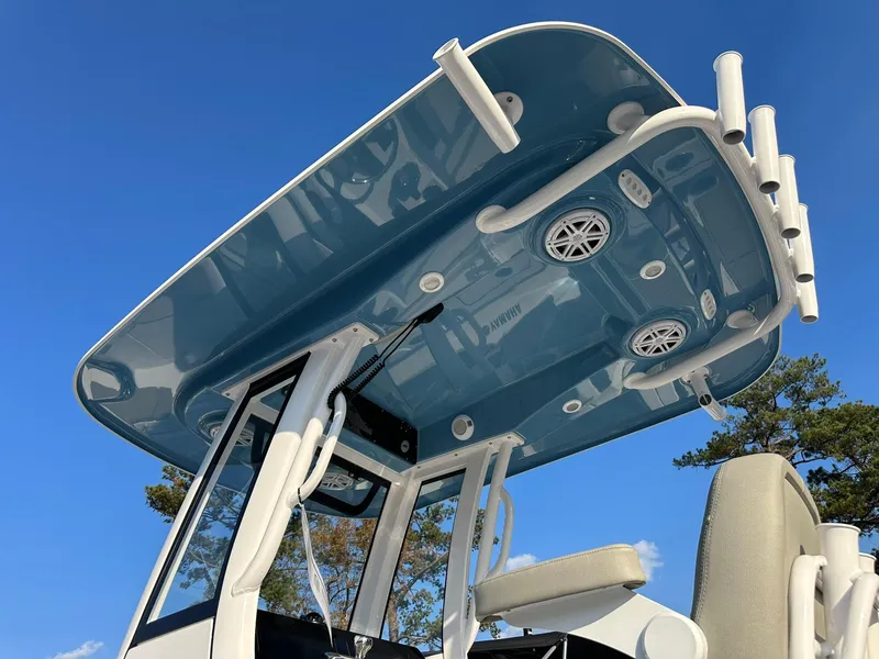 Slide: The Image of 2025 Sportsman Open 232 Center Console boat with blue T-top and rod holders. - 4