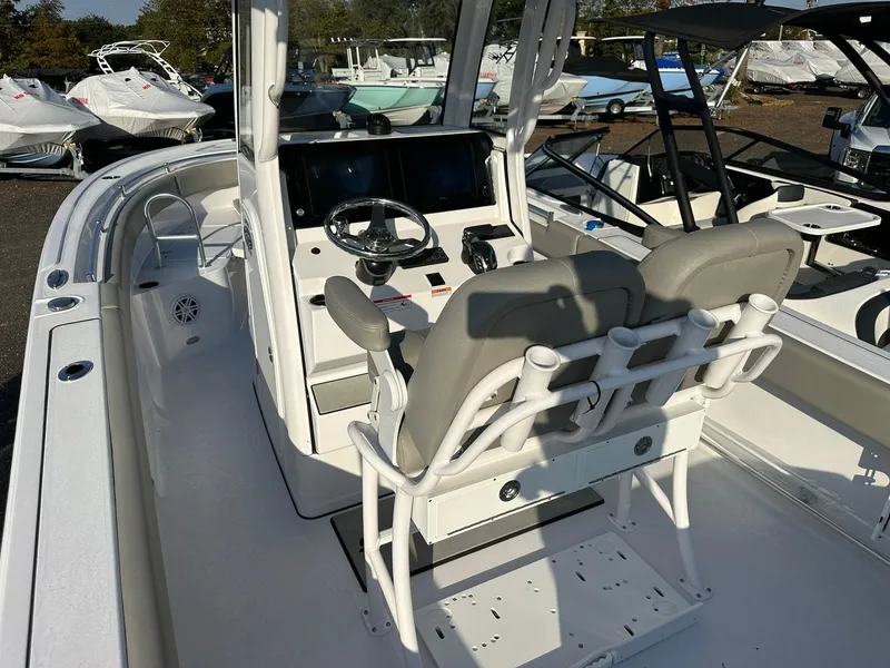Slide: The Image of 2025 Sportsman Open 232 Center Console boat interior with dual seats and steering console. - 9